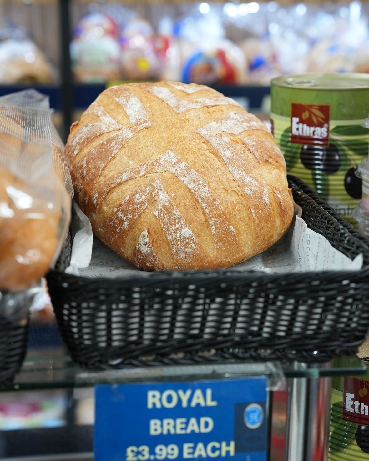 A round sourdough loaf on the bakery counter
